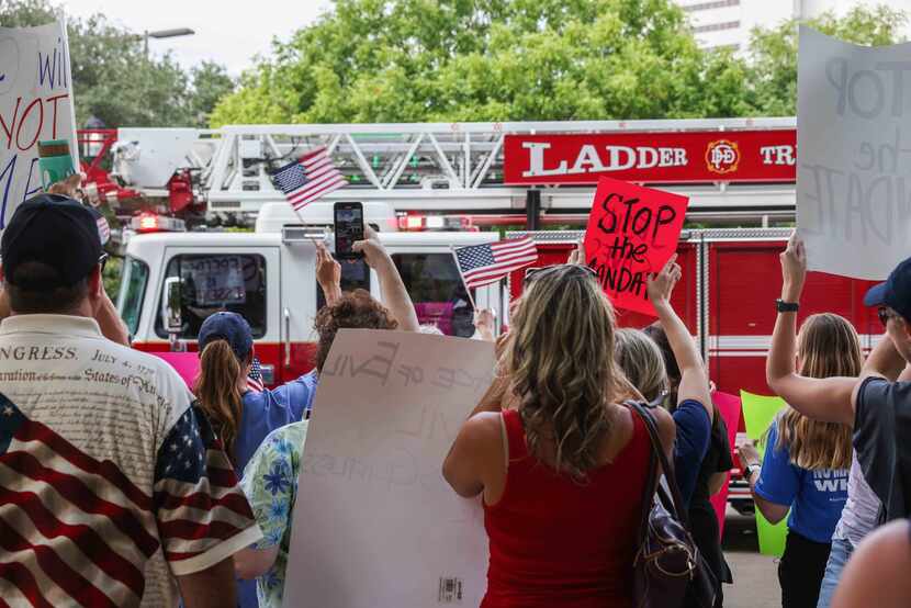 The horn from a passing Dallas Fire-Rescue truck blared in support of the protesters. 