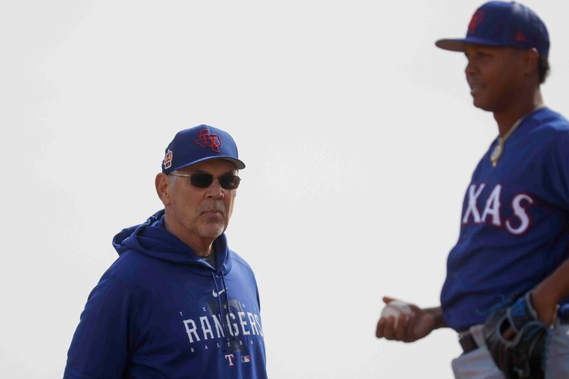 Texas Rangers manager Bruce Bochy, left, observes pitcher Jose Leclerc during spring...