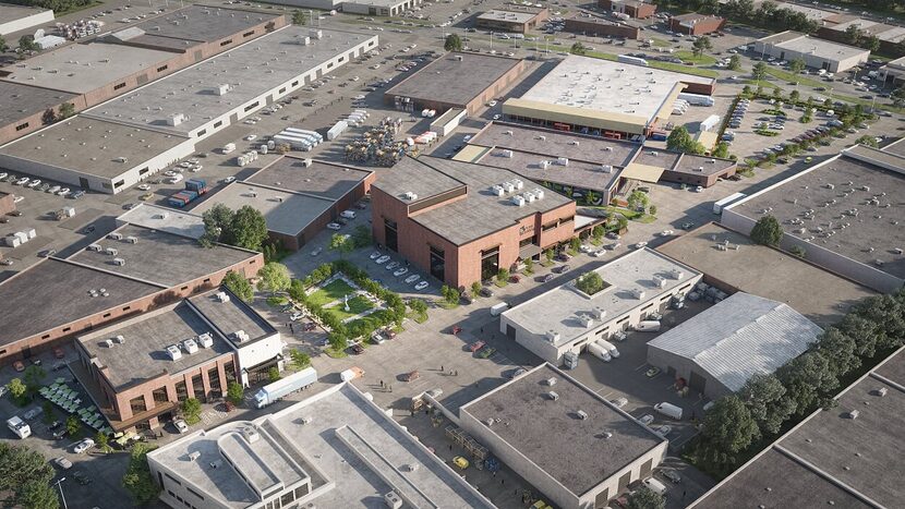 The two new buildings and a park replace an old manufacturing building.