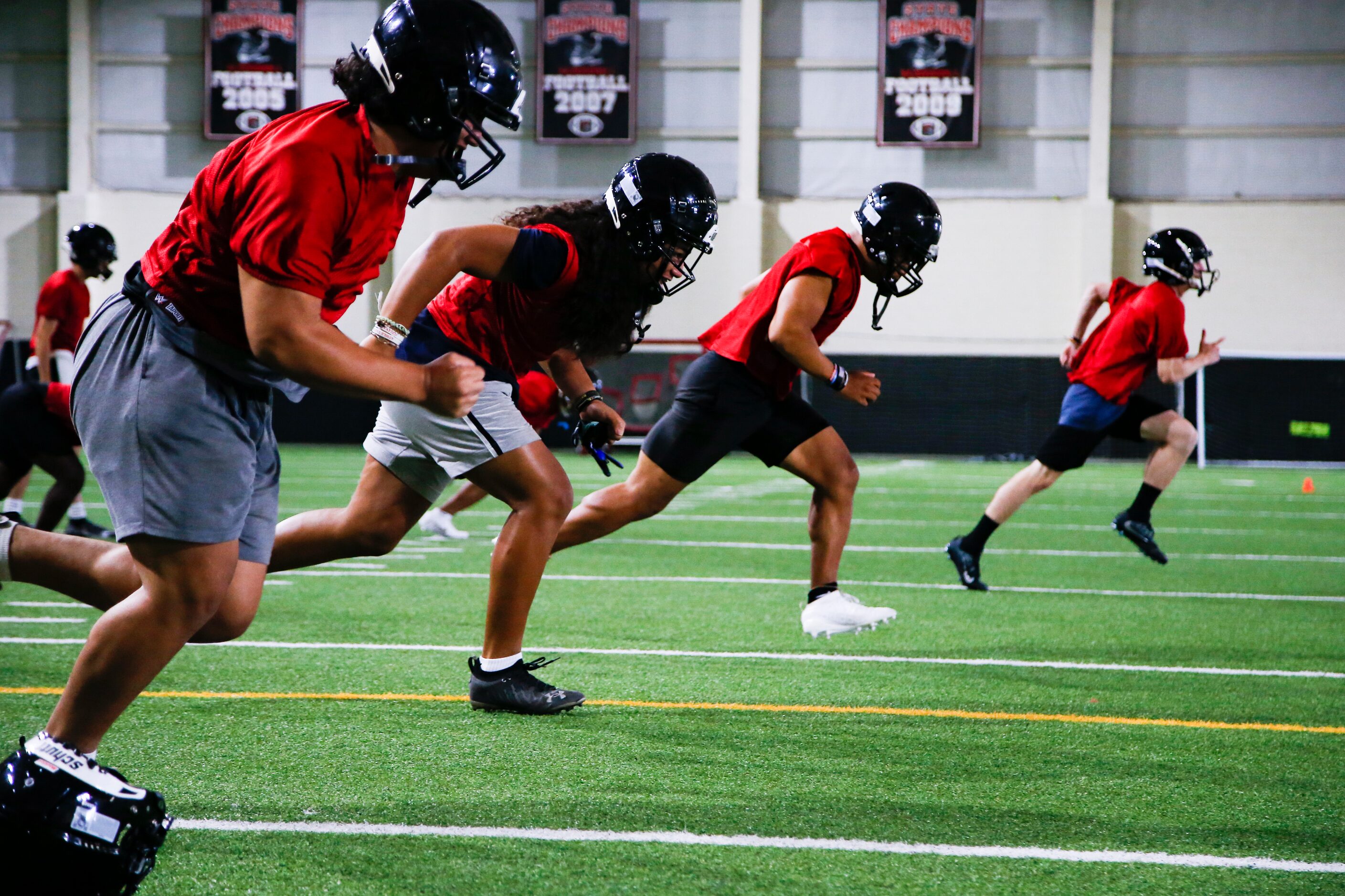 Euless Trinity’s varsity football team runs drills during a practice at Euless Trinity High...