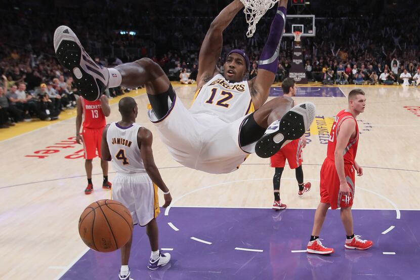 LOS ANGELES, CA - NOVEMBER 18:  Dwight Howard #12 of the Los Angeles Lakers hangs on the rim...