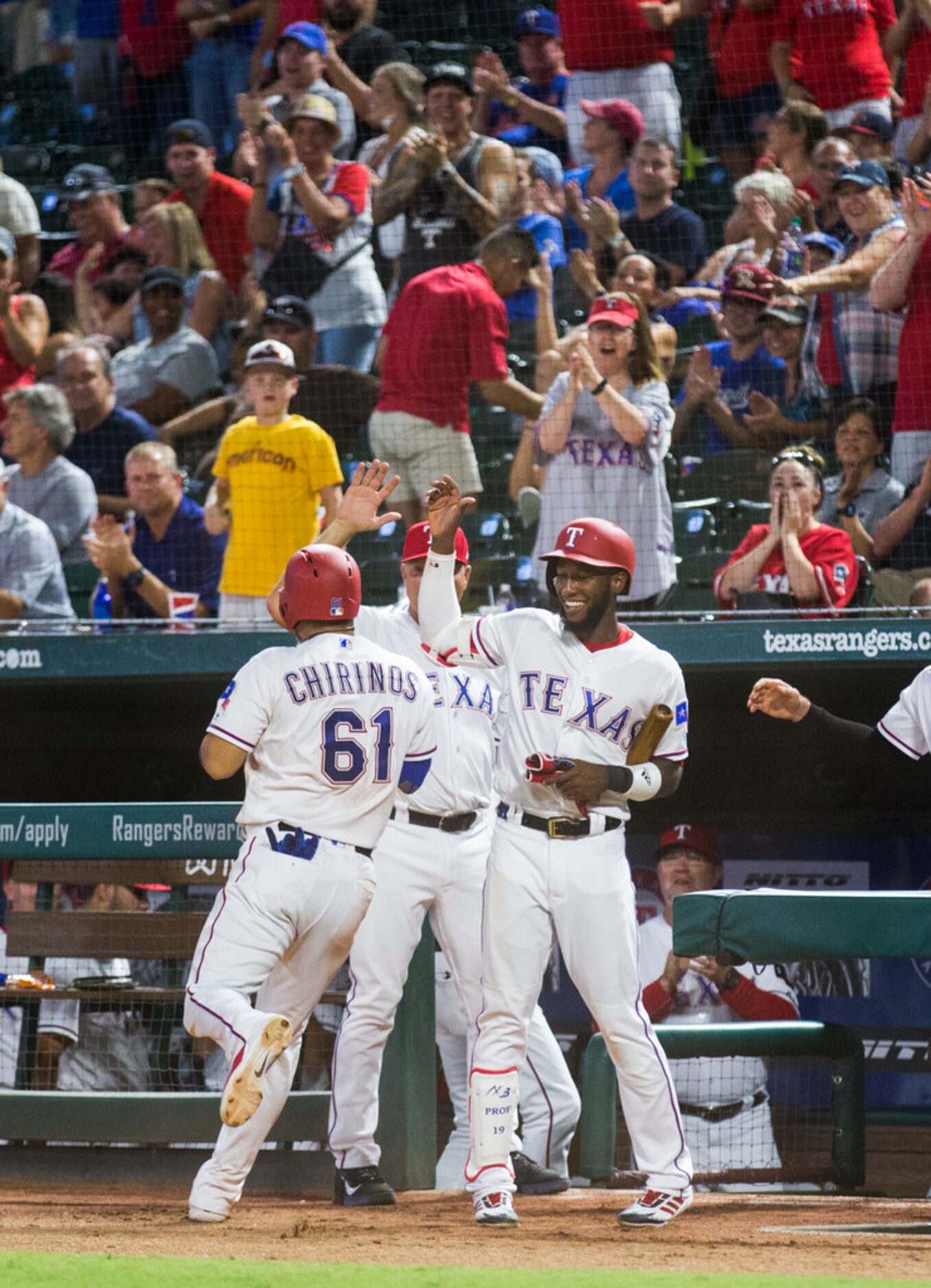 Texas Rangers catcher Robinson Chirinos (61) celebrates with shortstop Jurickson Profar (19)...