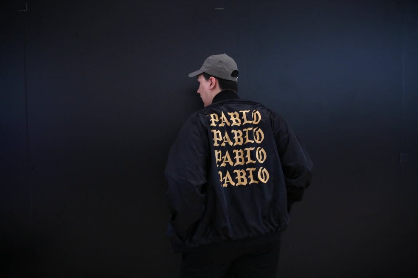 Zack Almanza poses with his black satin bomber jacket, which runs $250, outside Kanye West's...