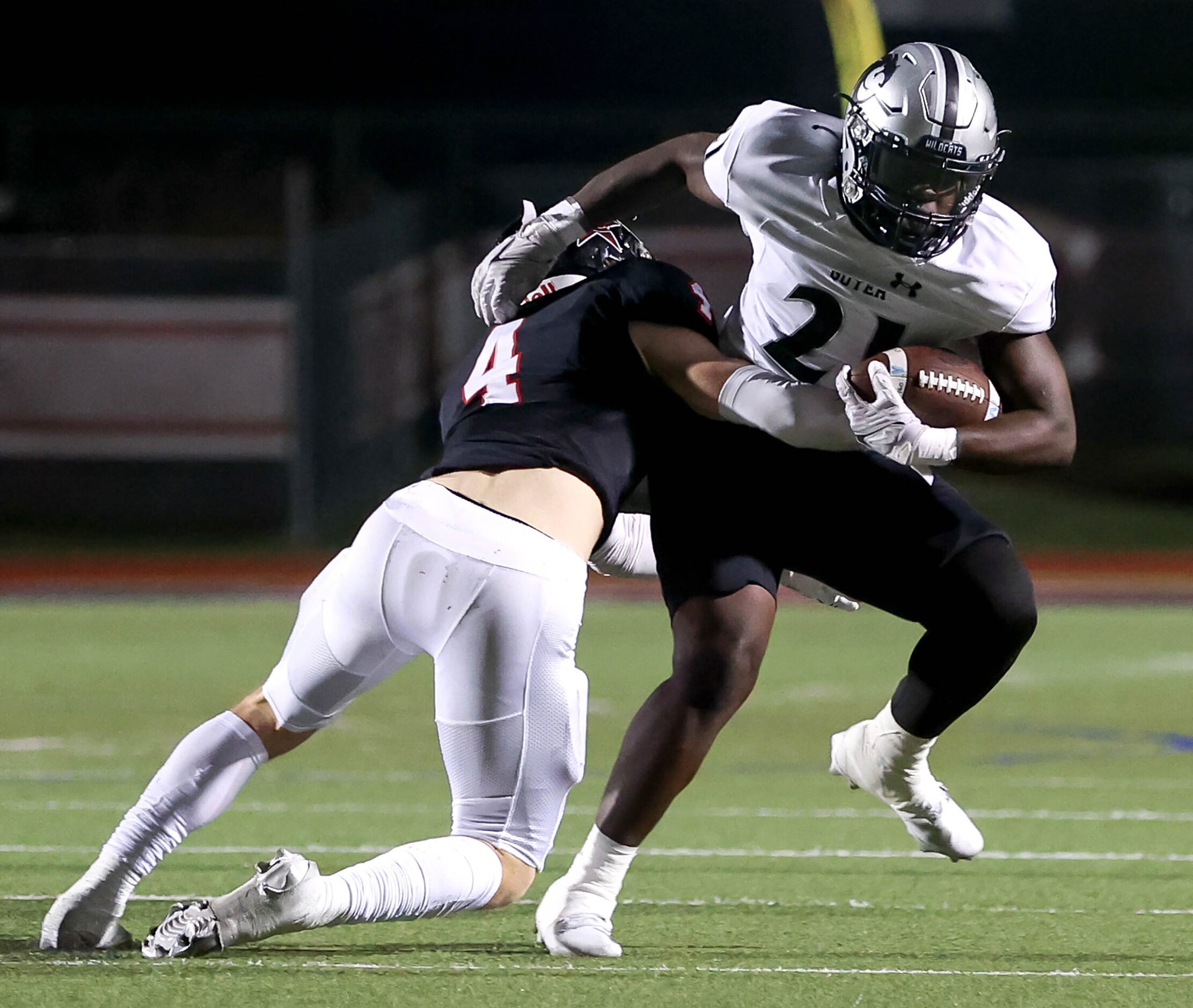 Denton Guyer running back Ahmed Yussuf (21) tries to break free from Coppell safety Scott...