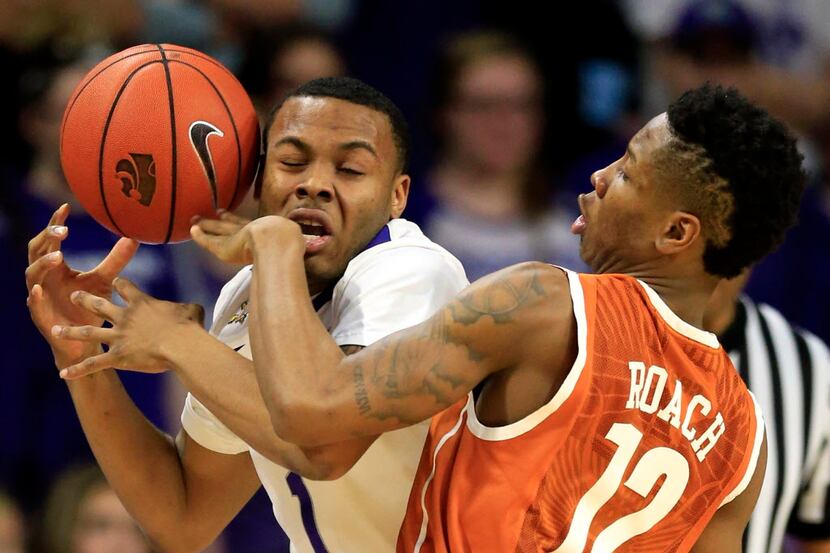Kansas State guard Carlbe Ervin II (1) is fouled by Texas guard Kerwin Roach Jr. (12) during...