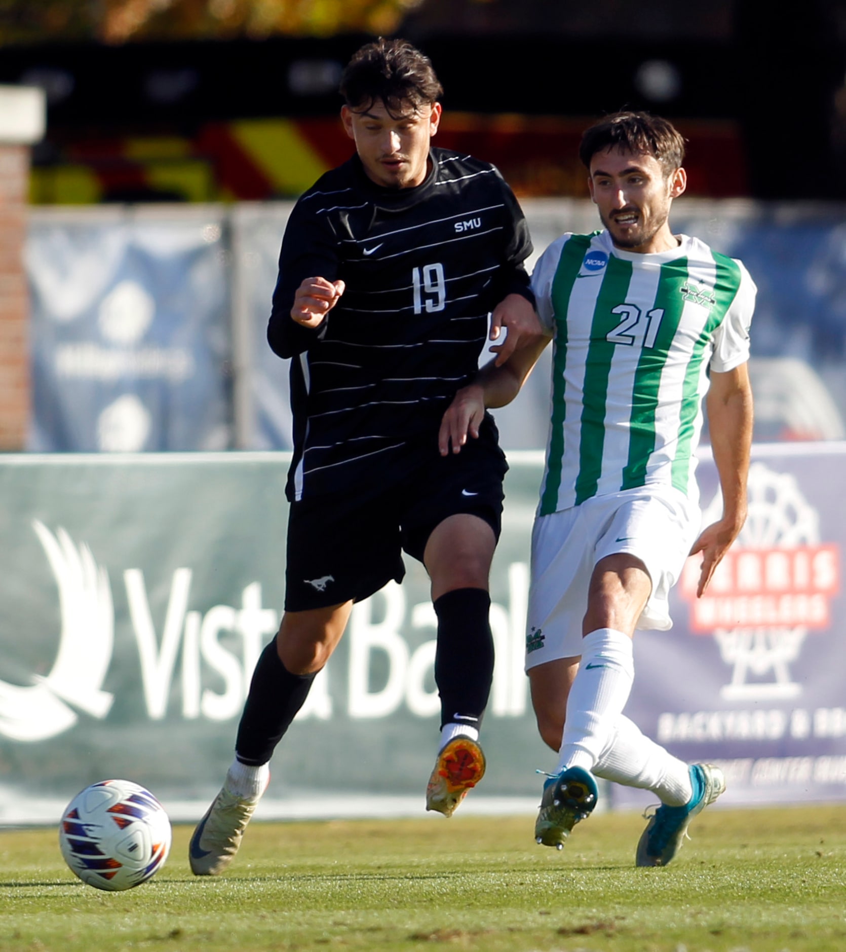 SMU forward Milton Lopez (19), left, battles for possession with Marshall midfielder Theo...