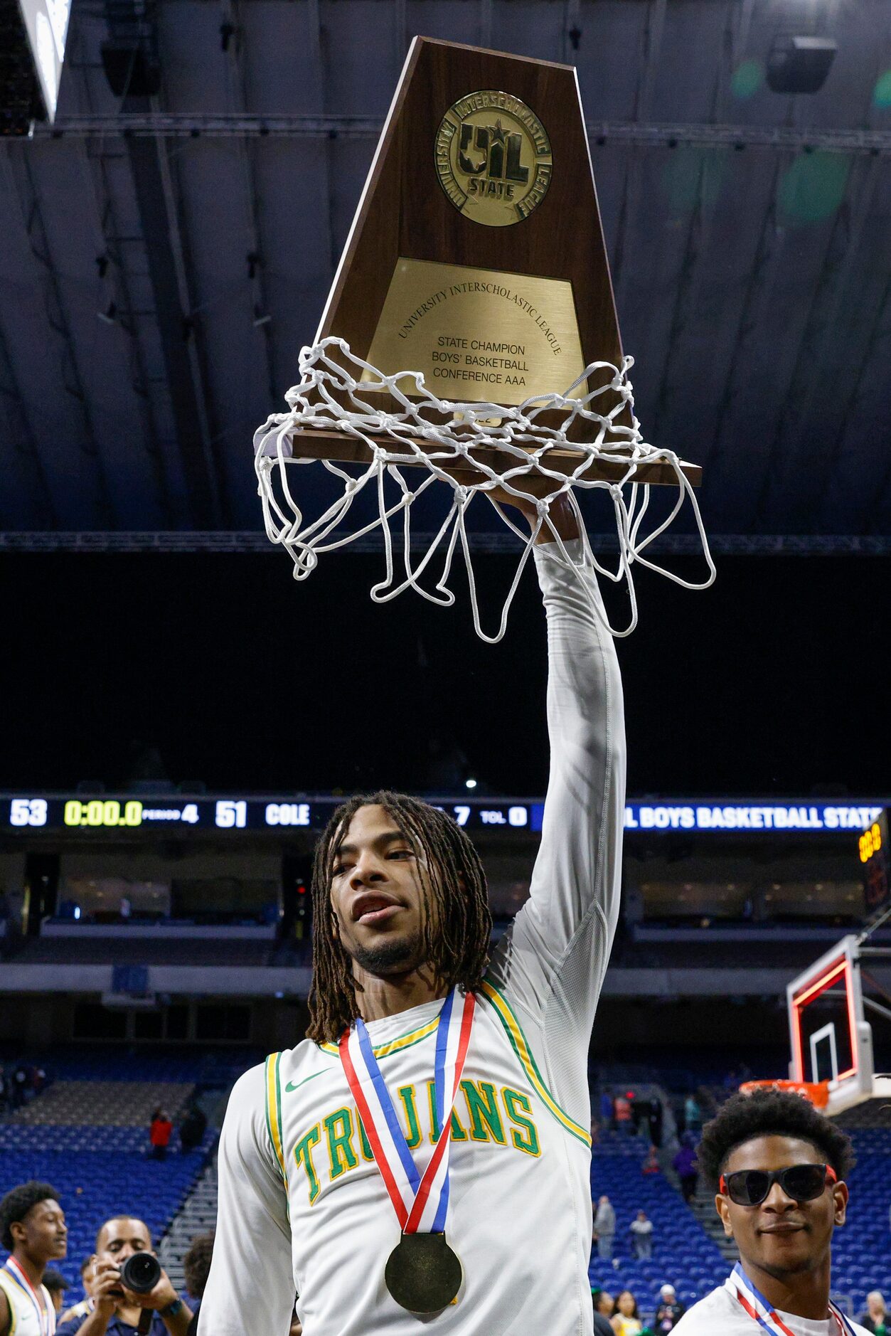 Madison guard Pierre Hunter (1) raises the Class 3A state championship trophy at the...