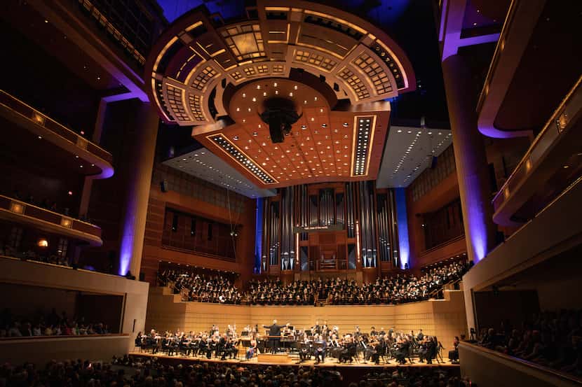 Interior of the Morton H. Meyerson Symphony Center, with dozens of musicians performing...
