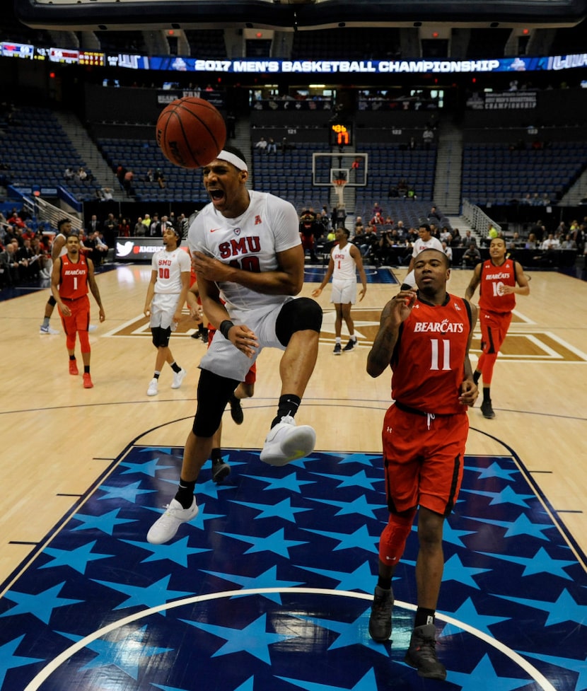 SMU guard Jarrey Foster dunks over Cincinnati Bearcats forward Gary Clark in the American...