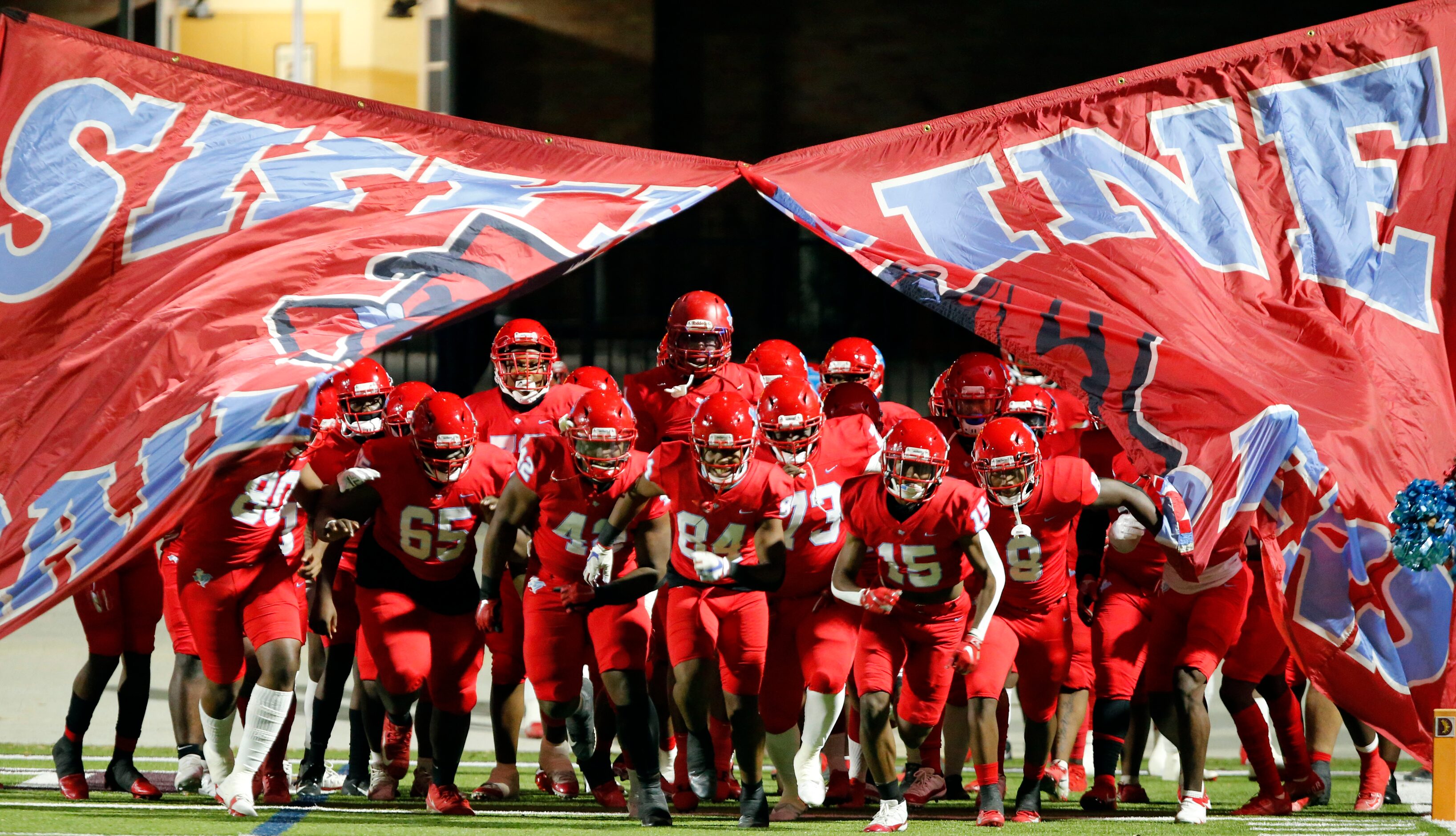 The Skyline High takes the field before the start of a high school football game against...