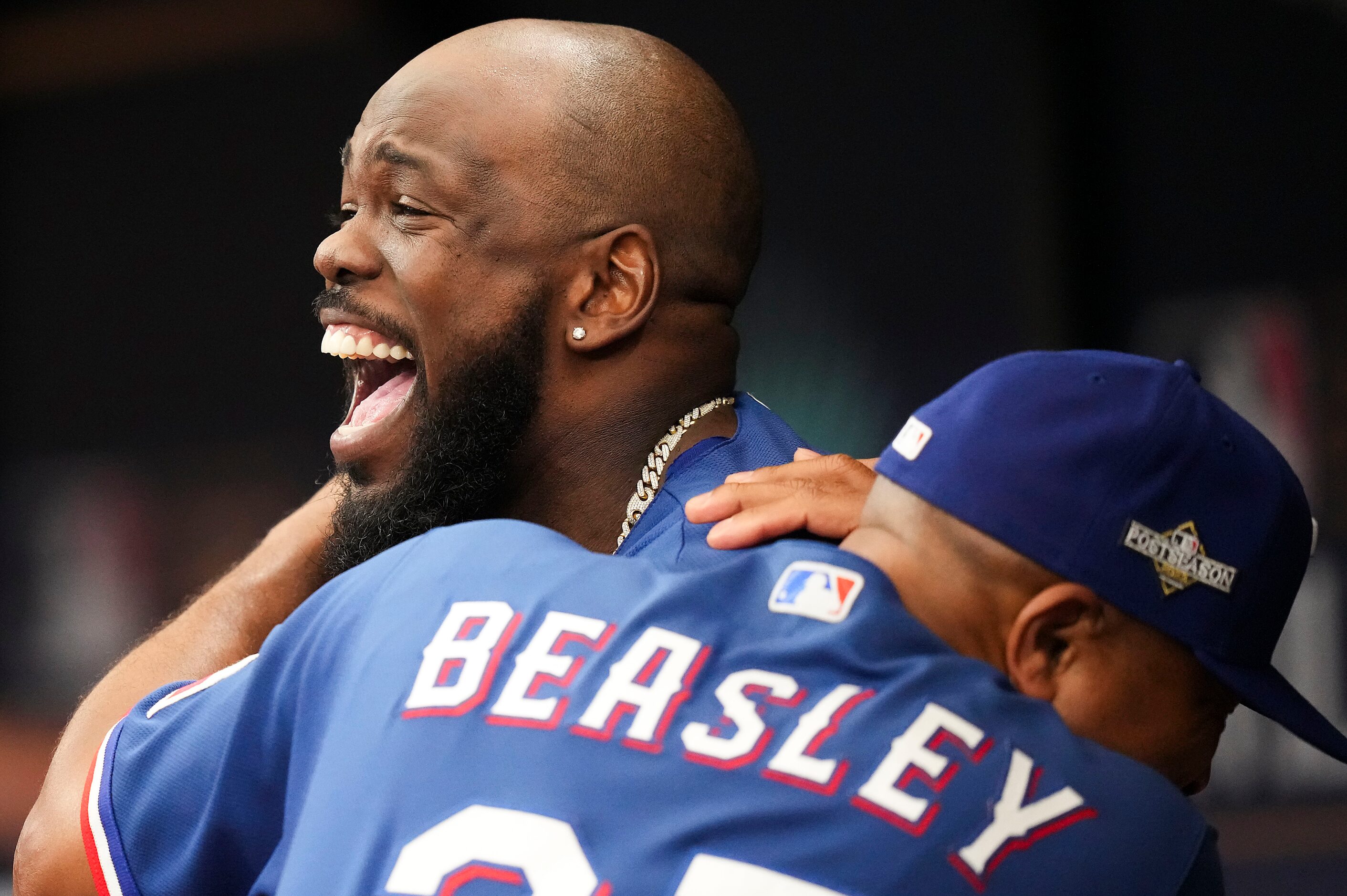 Texas Rangers right fielder Adolis Garcia (53) laughs in the dugout with third base coach...