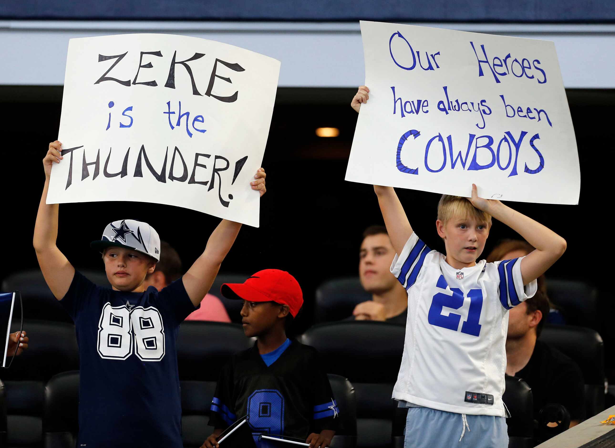 Young fans sign their approval of the Cowboys during the second half of a NFL football game...