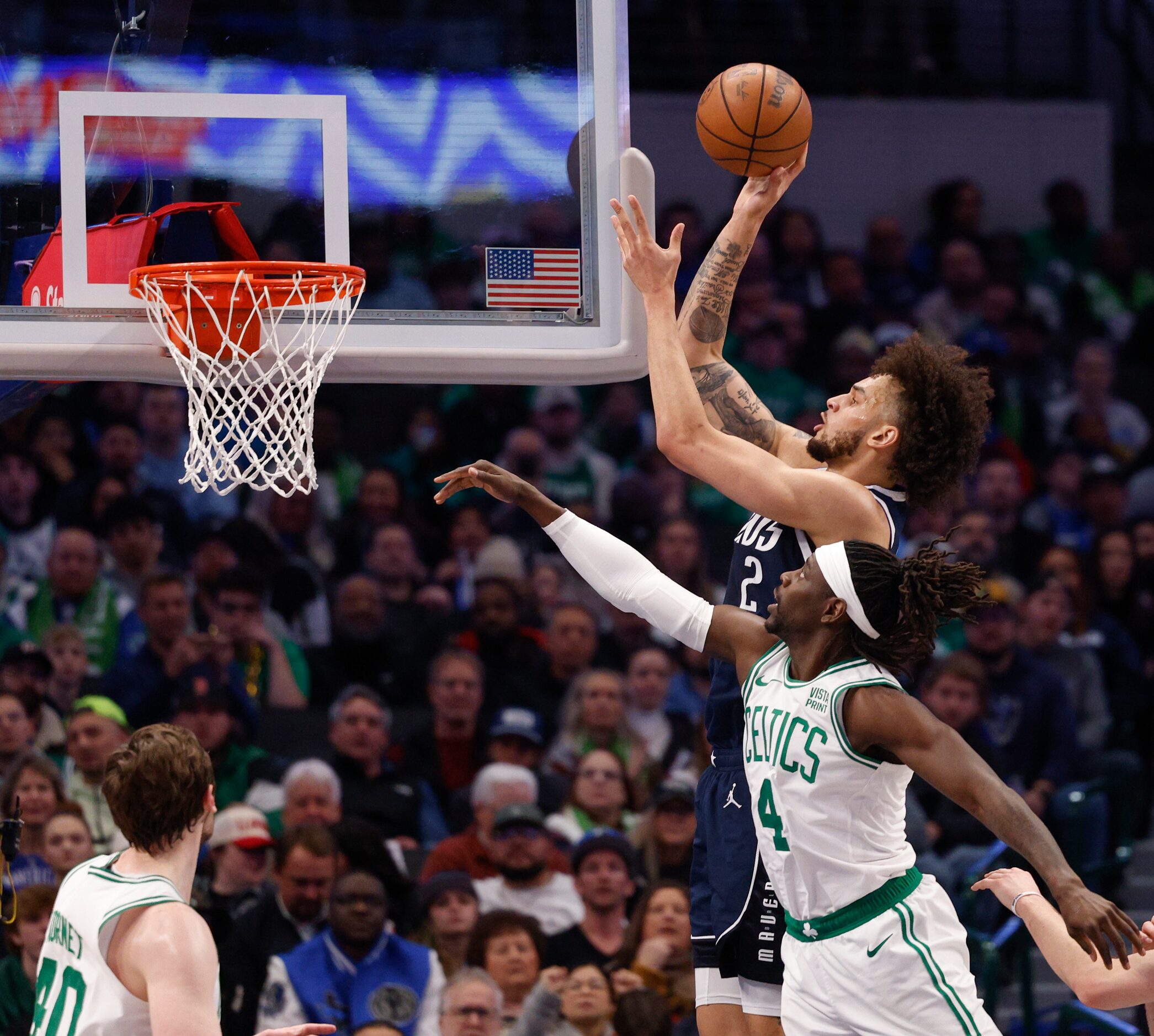 Dallas Mavericks center Dereck Lively II (2) shoots over Boston Celtics guard Jrue Holiday...