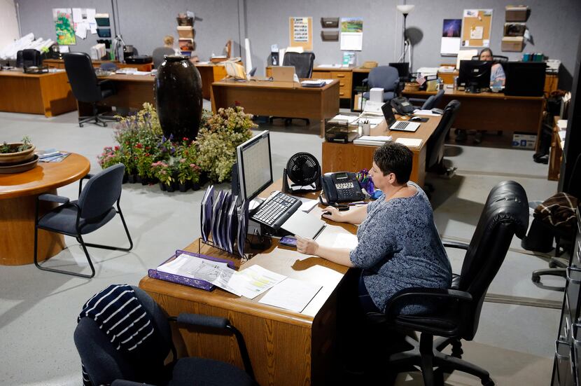 Work spaces at Highland Landscaping in Southlake have been spaced out so employees can...