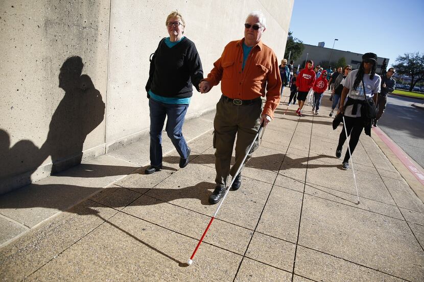 Rick and Suzanne Hardebeck walk around city hall to celebrate living independent as part of...