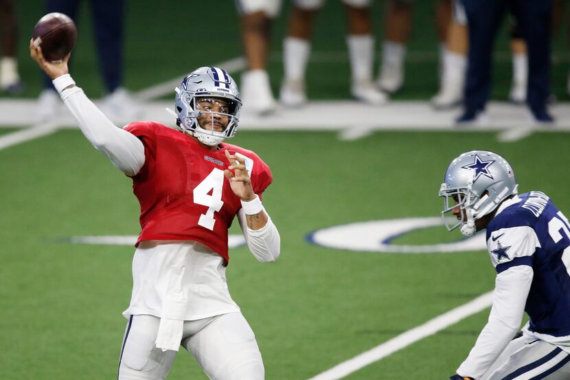 Dallas Cowboys quarterback Dak Prescott (4) attempts a pass as Dallas Cowboys safety Ha Ha...
