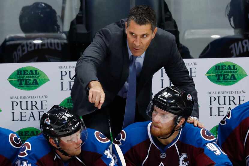 Colorado Avalanche head coach Jared Bednar, back, directs center Carl Soderberg, front left,...