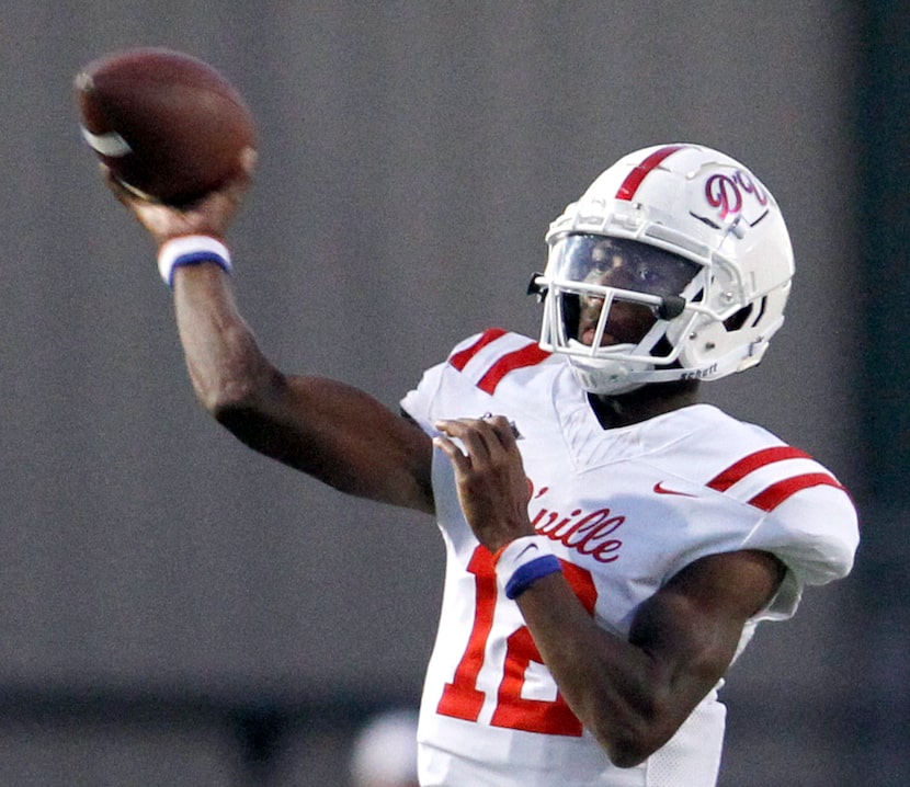 Duncanville quarterback Keelon Russell (12) launches a pass downfield during second quarter...