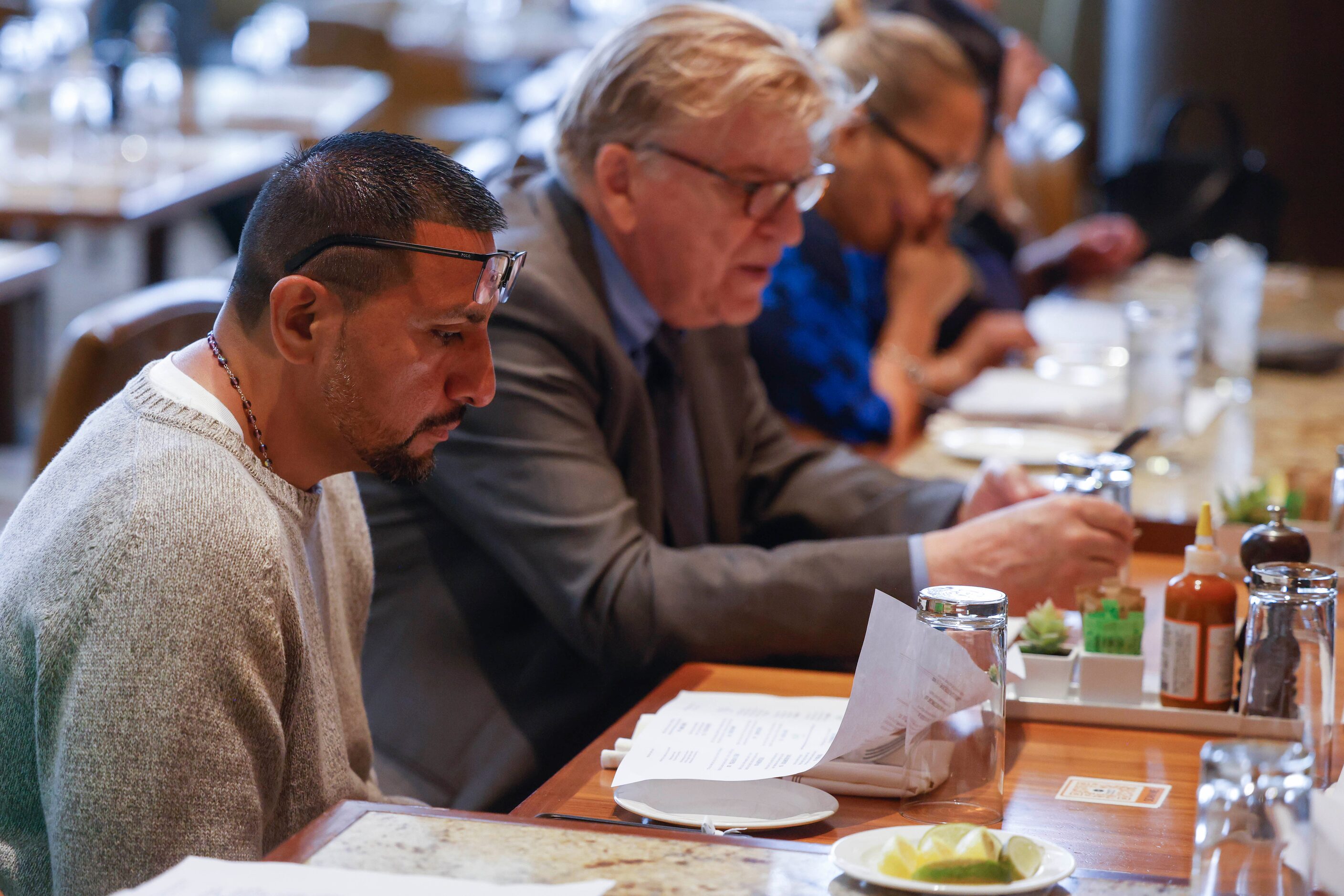 Martin Santillan reads the menu during a family lunch after he was formally exonerated of a...