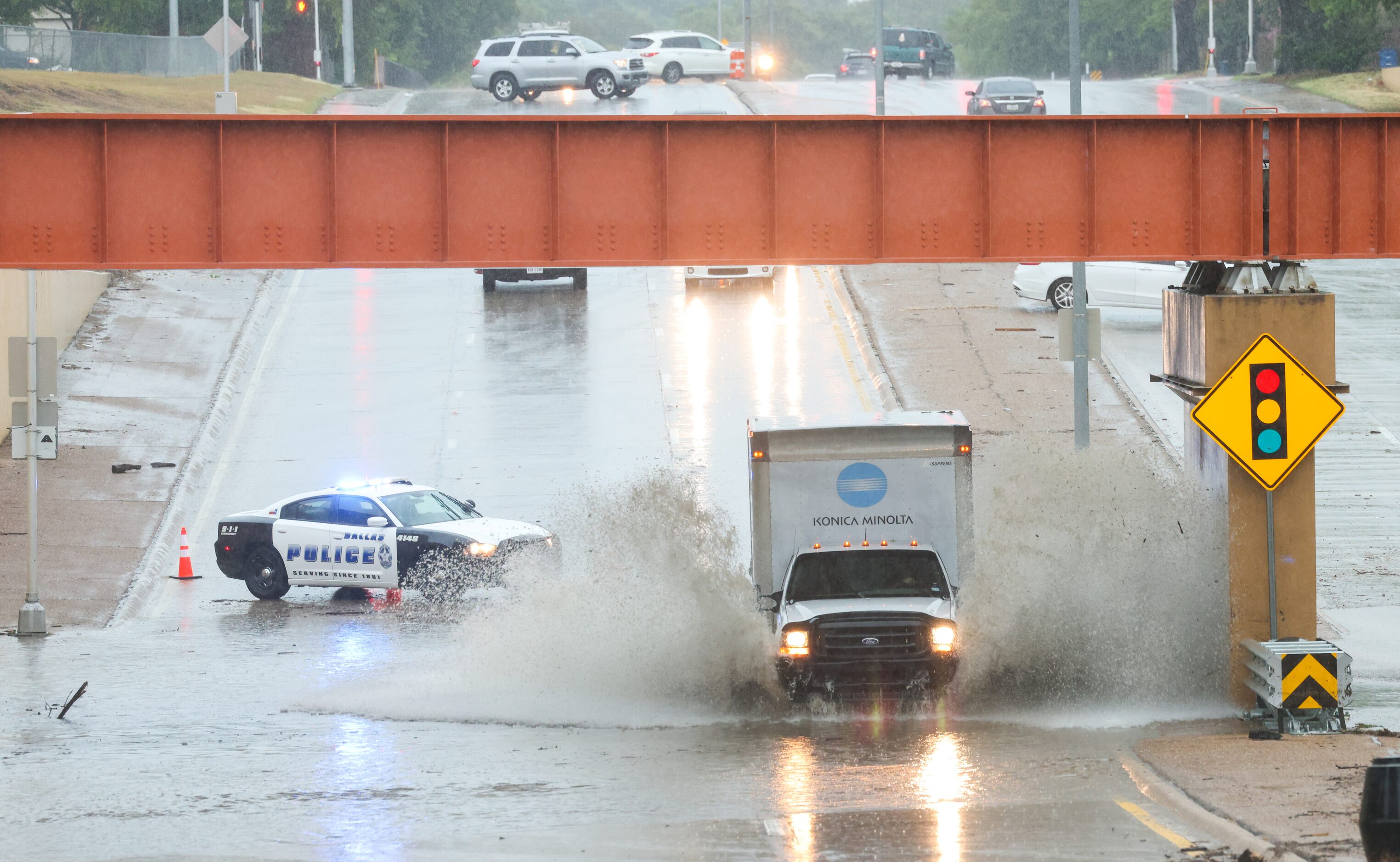 Cars navigate a flooding underpass on North Buckner Boulevard near an intersection with...