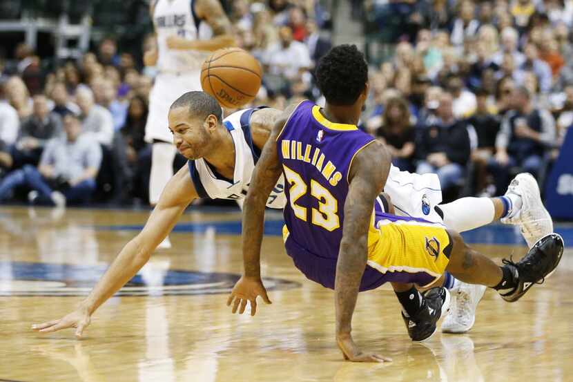 Dallas Mavericks guard Devin Harris (34) runs into Los Angeles Lakers guard Louis Williams...