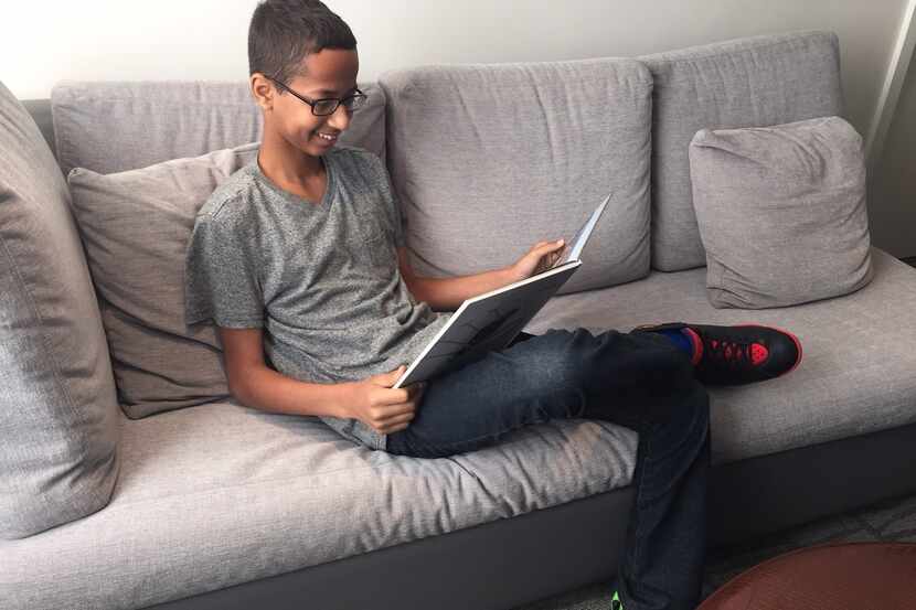  Ahmed Mohamed reads in a Washington, D.C. hotel room on Mon. Oct. 19, 2015 before he...