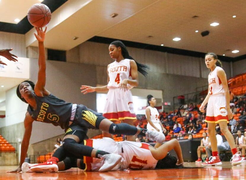 DeSoto guard Bria Patterson (5) falls on South Grand Prairie guard Kamryn Arrington (10)...