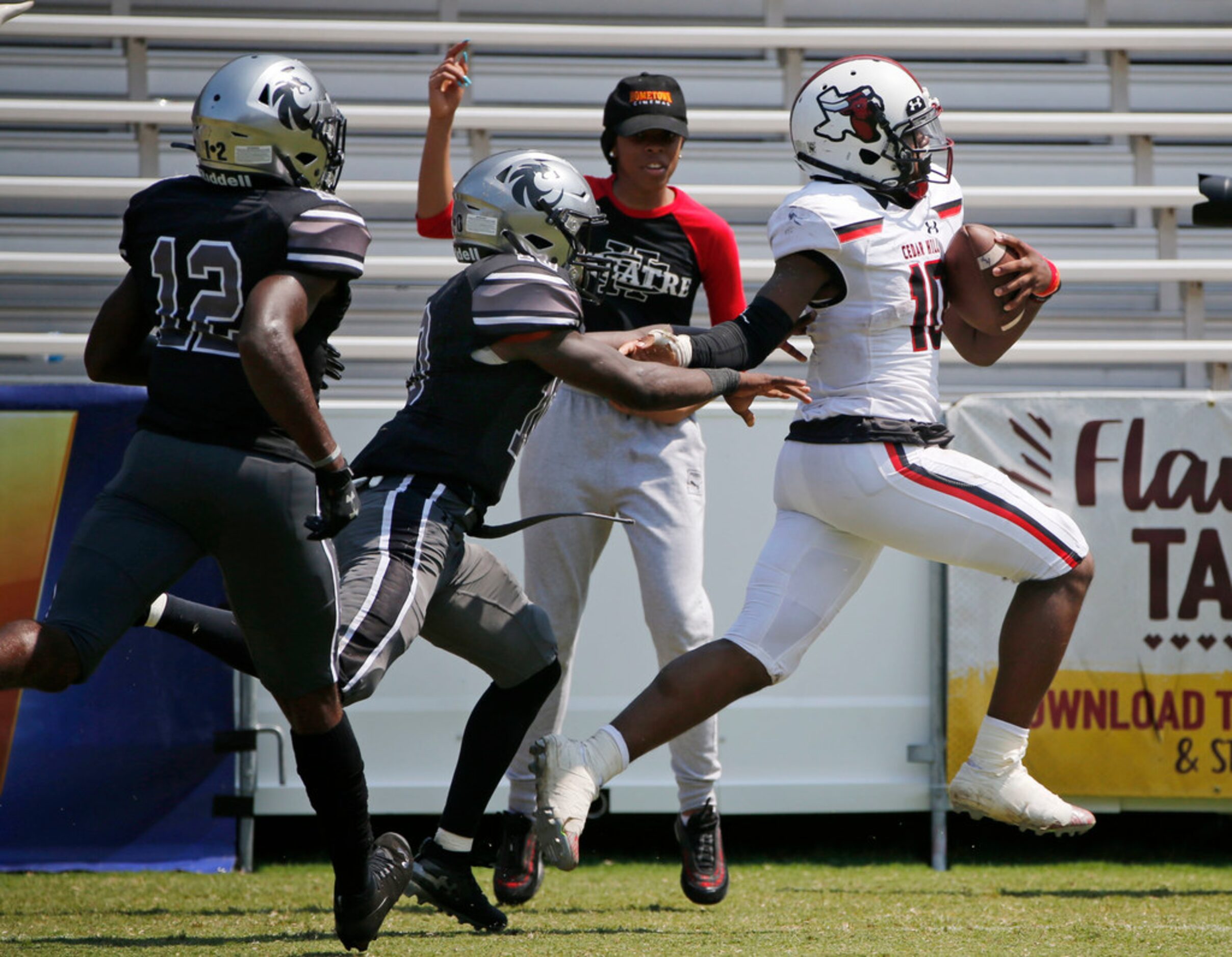 Cedar Hill's Corey Allen (10) scores a touchdown as Denton Guyer's Zion Settles (10) and...