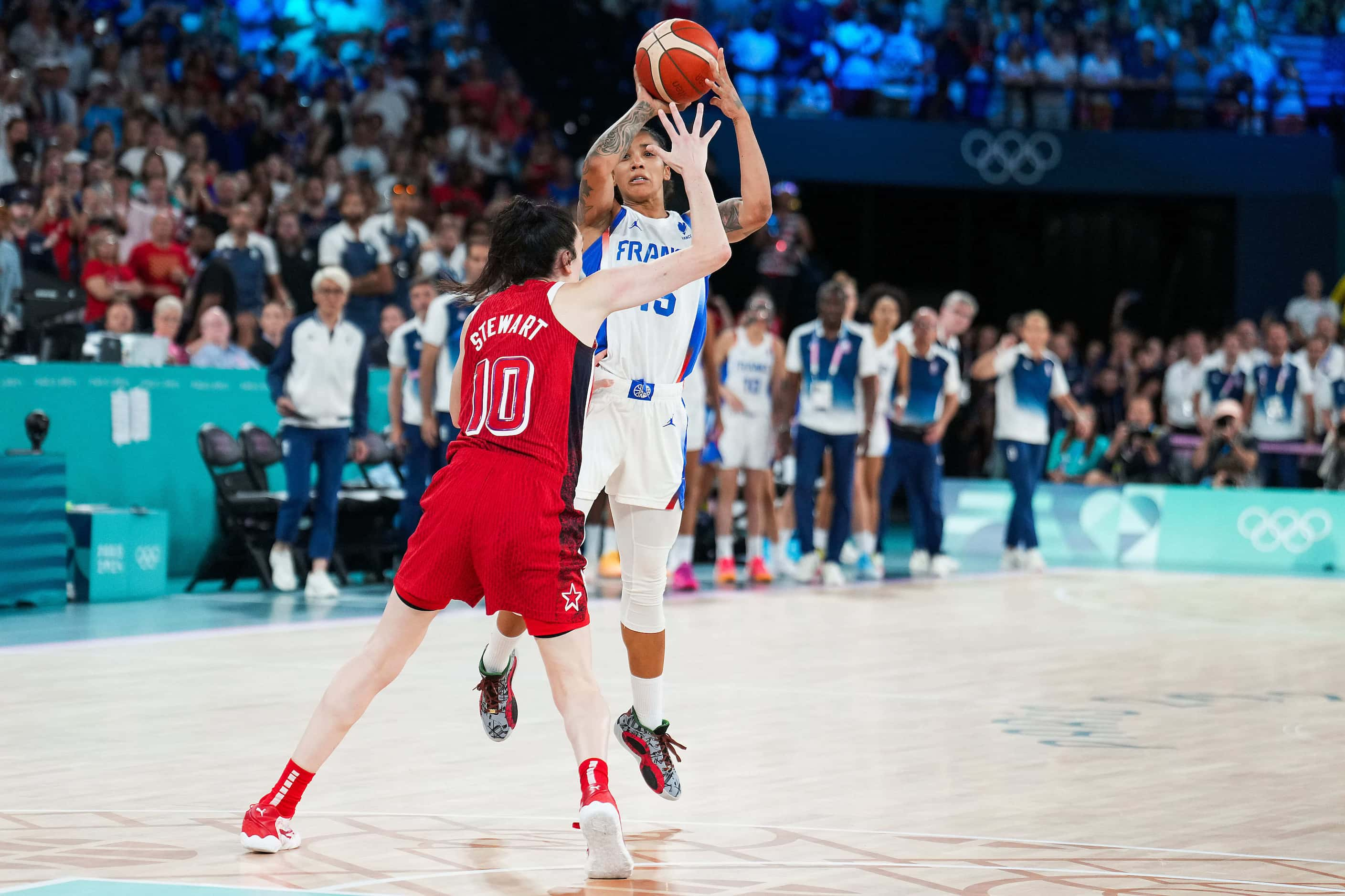 Gabby Williams (15) of France hits a buzzer beater over Breanna Stewart (10) of the United...