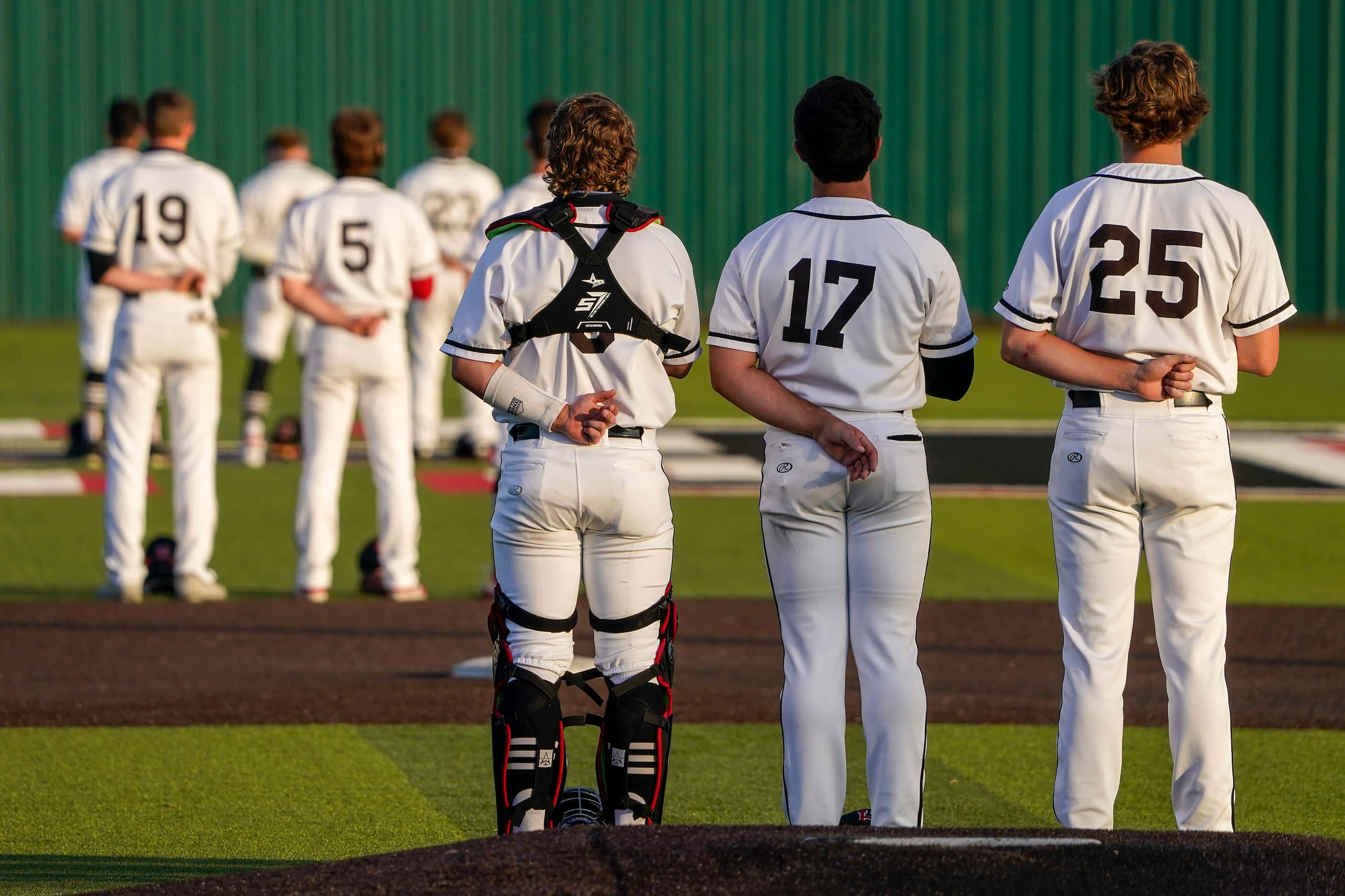 Rockwall-Heath players, including catcher Kevin Bazzell (9), pitcher Josh Hoover (17) and...