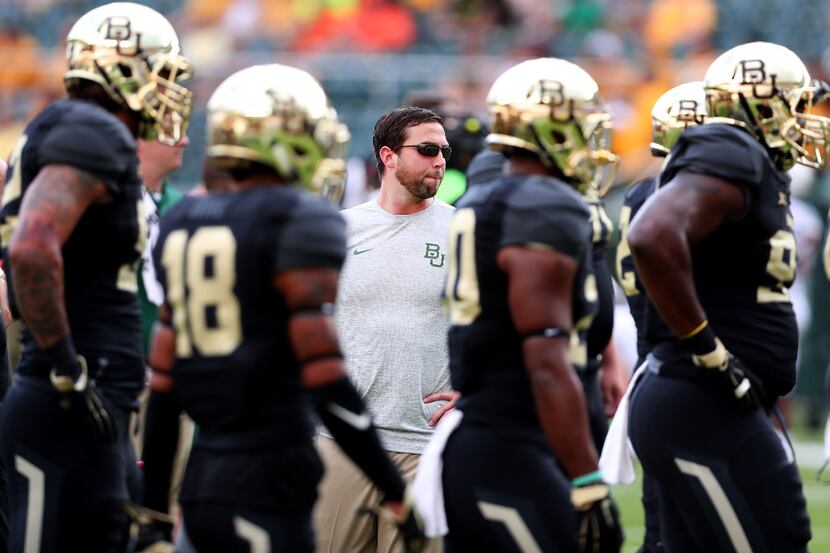 Offensive coach Kendal Briles and members of the Baylor football team.