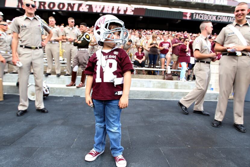 Yosef Herrera, 6, of McAllen, Texas, wears a Texas A&M football helmet as he plays his...