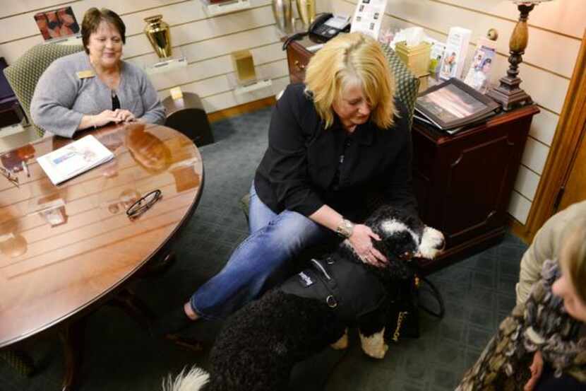 
Melody Brockway pets Candy, a grief therapy dog at Rest Haven funeral home in Rockwall,...