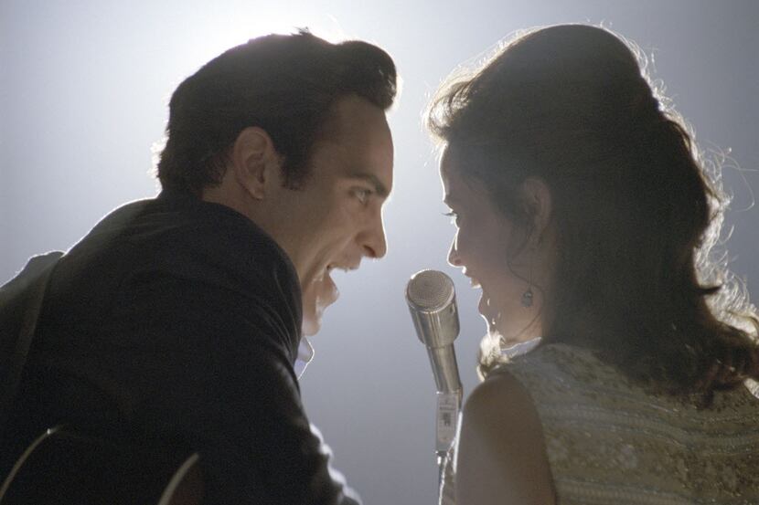 Musicians Johnny Cash (Joaquin Phoenix) and June Carter (Reese Witherspoon) perform in WALK...
