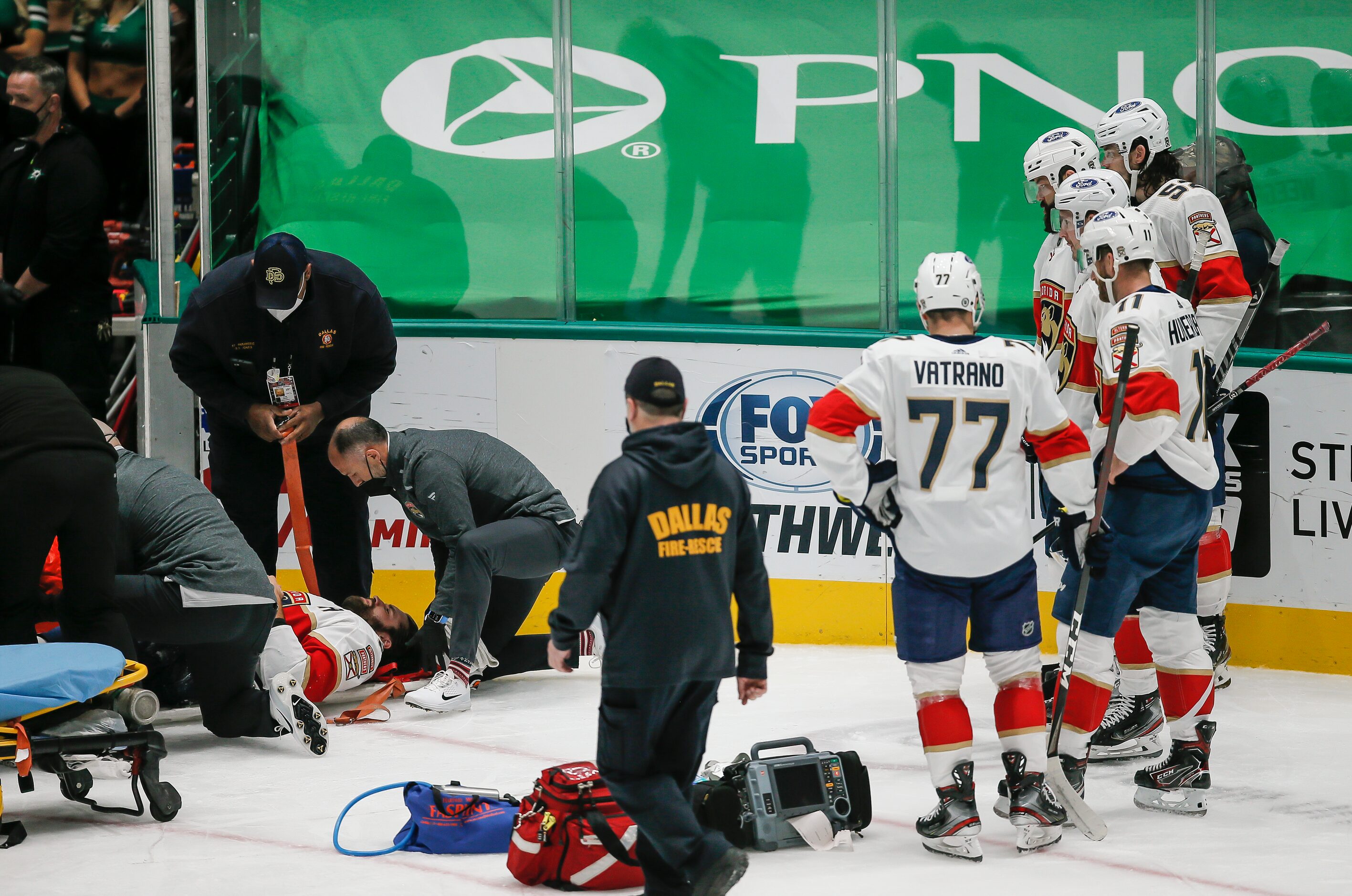 Florida Panthers defenseman Aaron Ekblad’s teammates look on as he is stretchered off the...