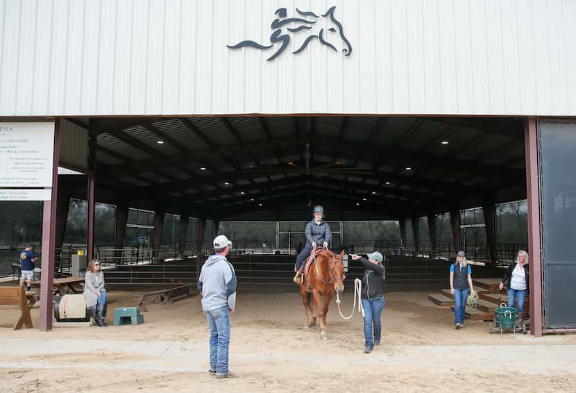 ManeGait Therapeutic Horsemanship instructor Antoinette Rand instructs Sara "Happy"...