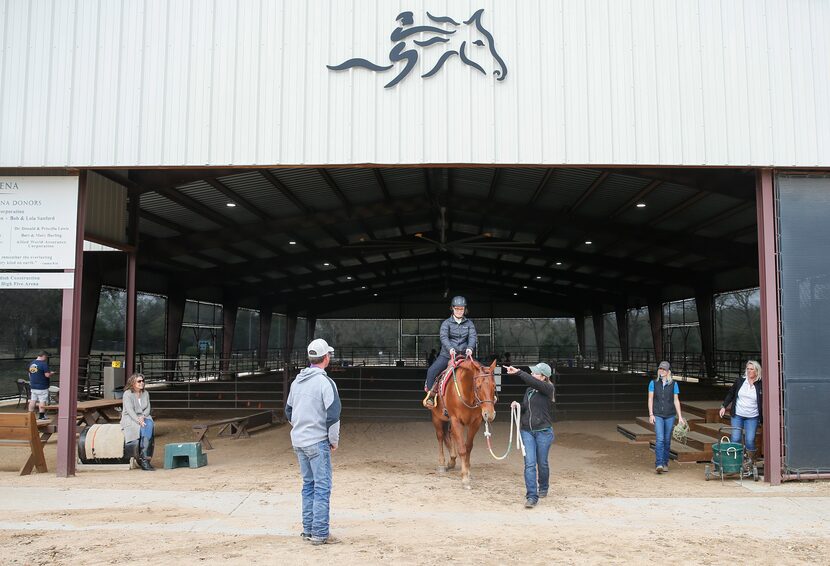 ManeGait Therapeutic Horsemanship instructor Antoinette Rand instructs Sara "Happy"...