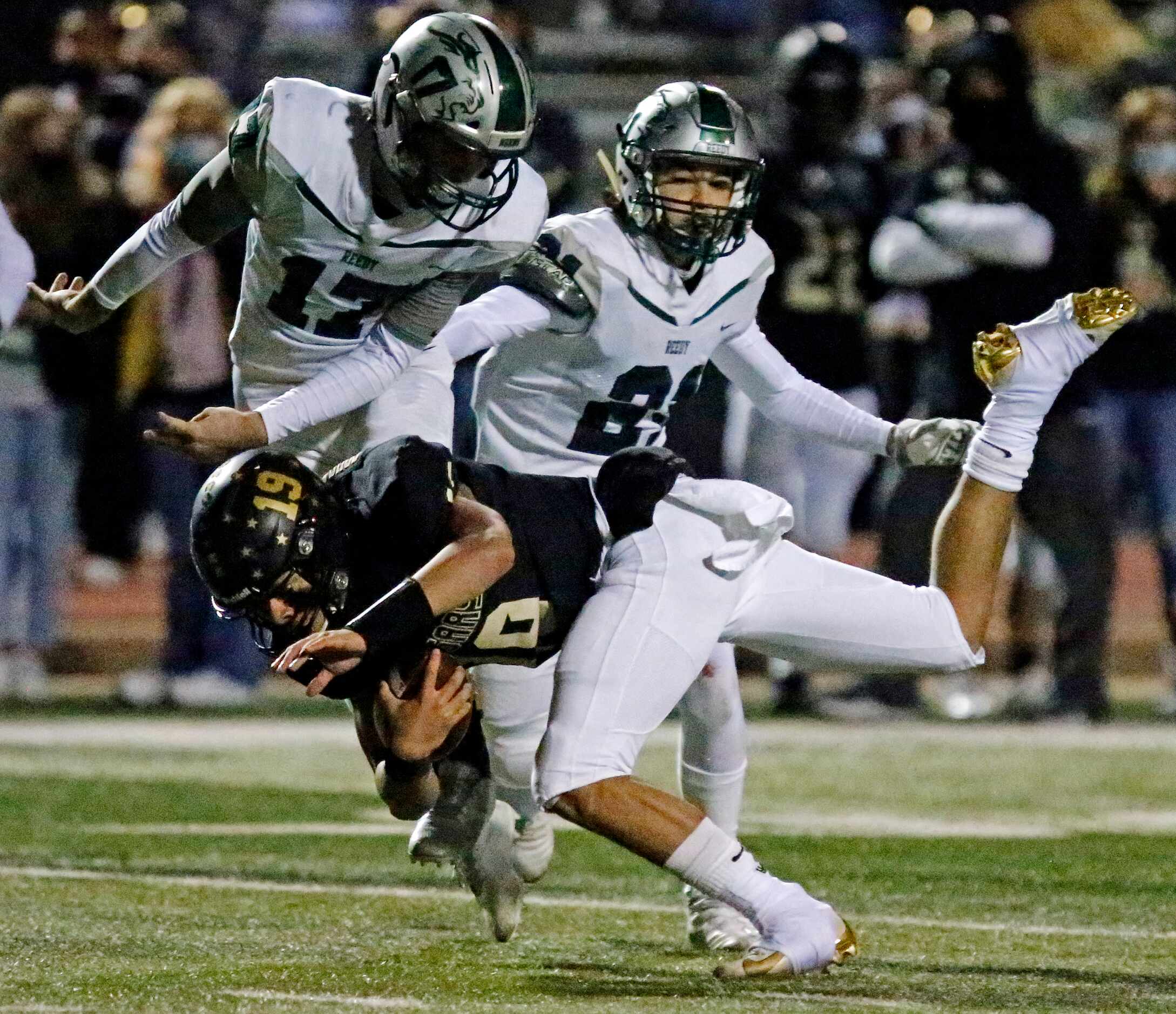 The Colony High School quarterback Jonathan Roberson (19) his thrown to the ground by Reedy...