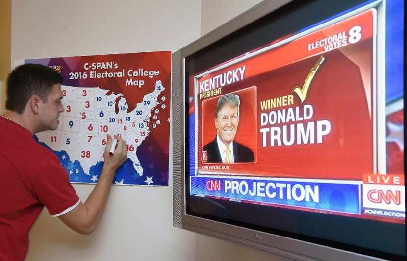 Jake Krupa colors in an electoral map as states are projected for Republican presidential...
