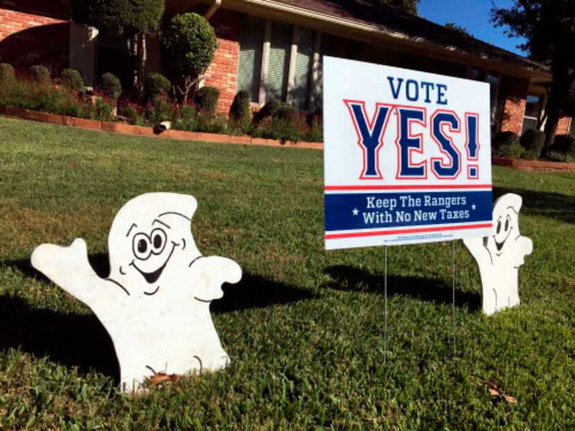 Halloween decorations adorn a Vote Yes sign in the front yard of a North Arlington home. The...