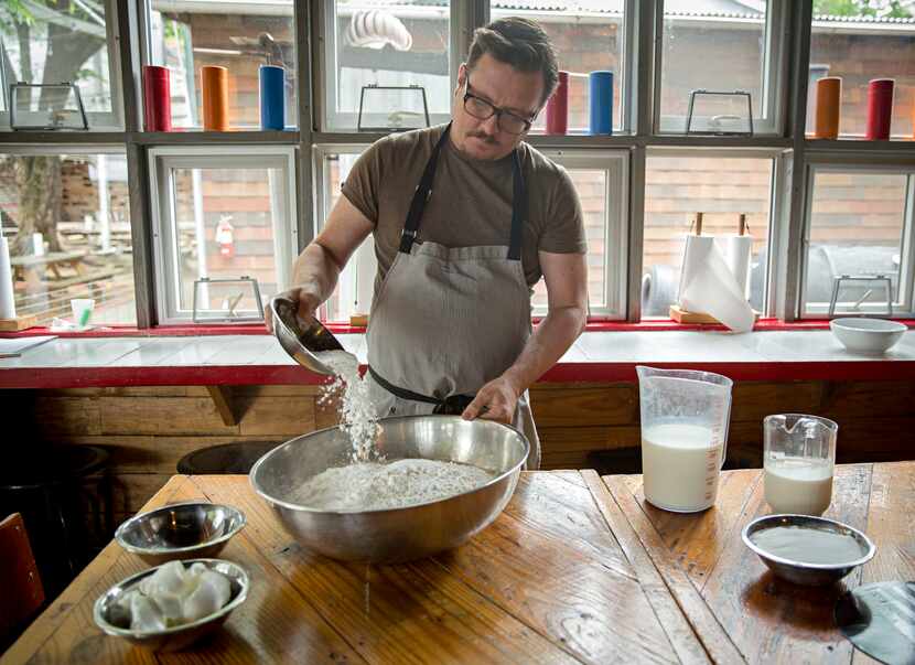 Chef Tim Byres mixes dry ingredients as he prepares buttermilk biscuits at Chicken Scratch...