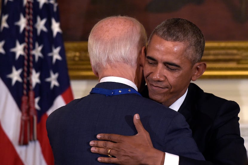 Vice President Joe Biden, left, hugs President Barack Obama, right, during a ceremony in the...