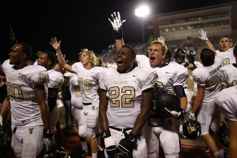 The Colony's Tyrone Brooks (22) and Caleb Dill (13) celebrate with their teammates after...