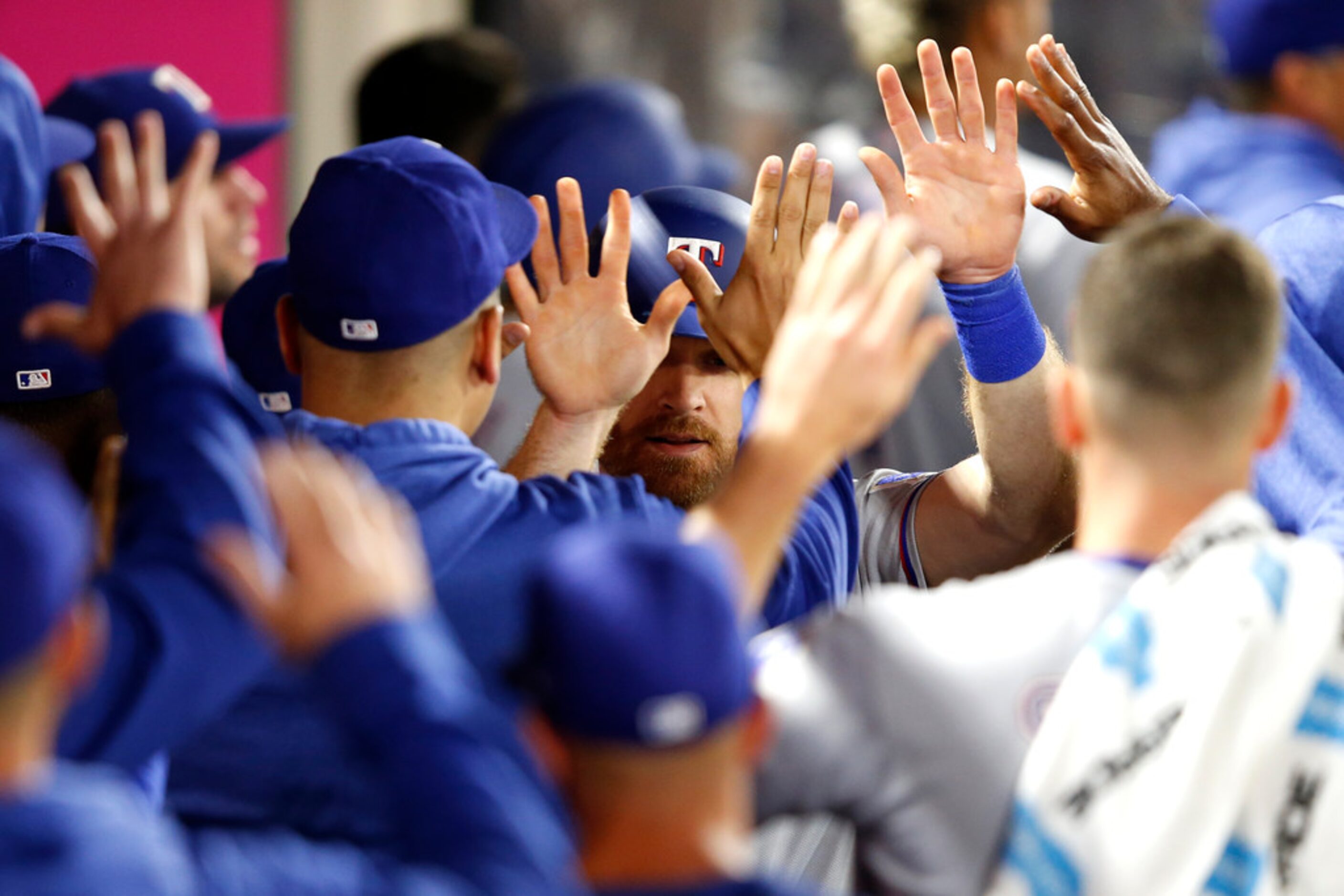 ANAHEIM, CALIFORNIA - MAY 24:  Logan Forsythe #41  is congratulated in the dugout after...