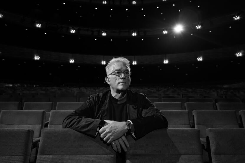 Executive Director at TITAS/Dance Unbound Charles Santos sits in a theater in Dallas.