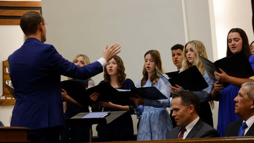 Alliance Youth Choir of The Church of Jesus Christ of Latter-day Saints sings with conductor...