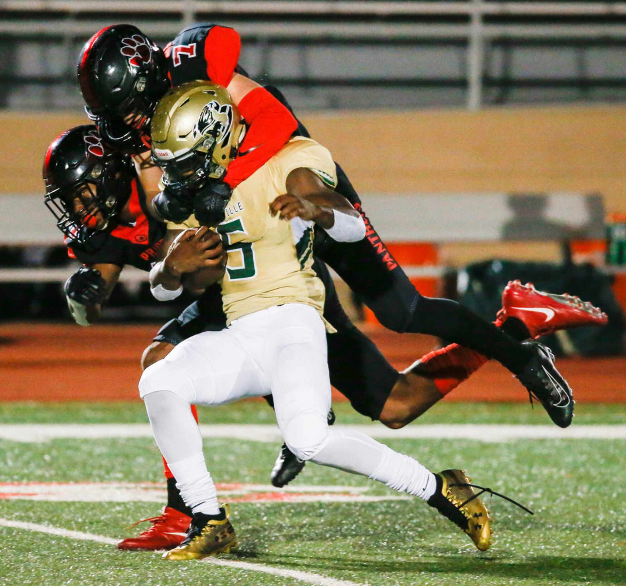 Colleyville Heritage defensive back Joshua Dobbins (11) and safety Luke Made (7) work to...