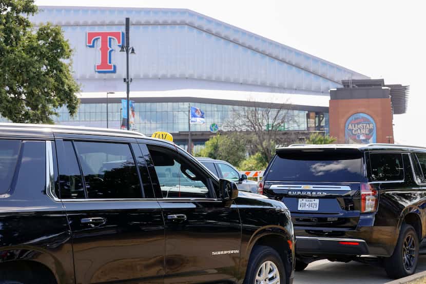 Several taxis and cars for hire are seen outside Globe Life Field during All-Star Weekend,...
