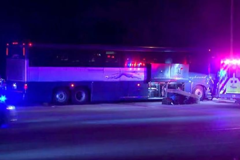 A Greyhound bus sits on Interstate 30 Friday morning in Fort Worth after a wreck sent eight...