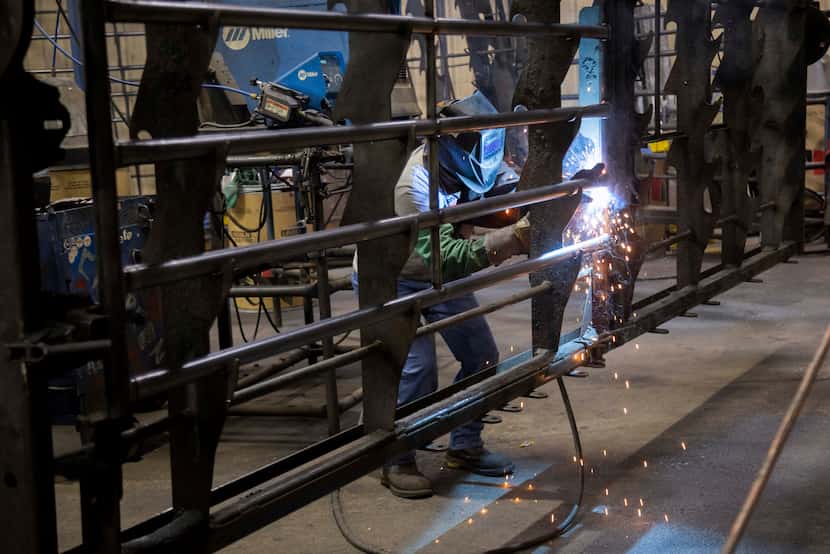 A welder works on a gate at Priefert Manufacturing in Mount Pleasant on Thursday, Nov. 16,...